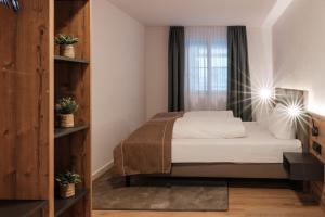 a small bedroom with a bed and a window at Ferienwohnung Beim Paschamarte in Schwangau