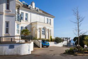 a blue car parked in front of a building at Breathtaking Views at The Bay in Torquay