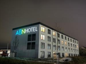 a building with a sign on the side of it at ABN Hotel by WMM Hotels in Altdorf bei Nuernberg