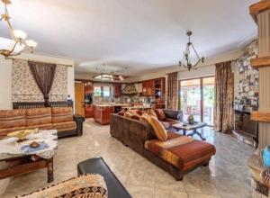 a large living room with couches and a kitchen at Stone Horizon Villa in Eretria
