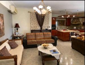 a living room with a couch and a table at Stone Horizon Villa in Eretria