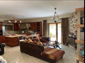 a living room with a couch and a kitchen at Stone Horizon Villa in Eretria
