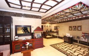 a large living room with a tv and a room with at Icon Hotel Apartments in Dubai