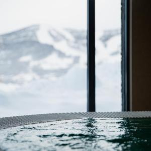 a reflection of a table in a room with a window at Vestlia Resort in Geilo