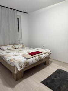 a bedroom with a bed in a white room at Turda central apartament in Turda