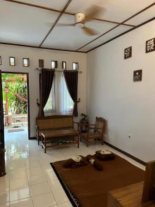 a living room with a couch and a ceiling fan at In Home stay in Bulakbenda
