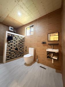 a bathroom with a toilet and a sink at JND Cozy Homes in Iringa +26 photos