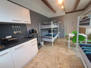 a kitchen with two bunk beds in a room at Boardinghouse Wildbachtal in Boxtal +57 photos