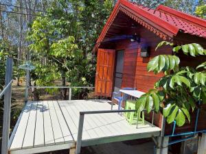 a small cabin with a wooden deck and a door at Meesaeng Homestay in Thalang +22 photos