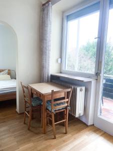 a table and chairs in a room with a window at Gästehaus am Main in Randersacker +27 photos