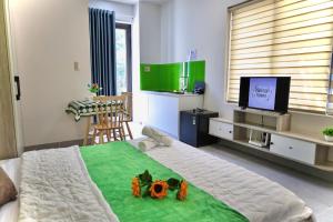 a bedroom with a large bed with flowers on it at Minimalhaven Stay in Vung Tau