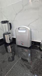 a toaster sitting on a counter next to a blender at Casa españa LUXURY in Tangier +6 photos
