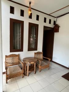 a patio with a table and two chairs and a light at In Home stay in Bulakbenda +3 photos