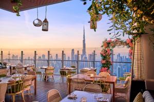 a restaurant with a view of the dubai skyline at SLS Dubai Hotel & Residences in Dubai