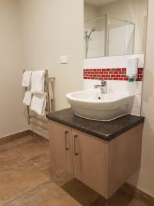 A bathroom at Ramada Suites by Wyndham Christchurch City