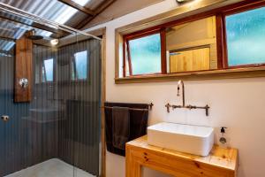 a bathroom with a sink and a shower at AfriCamps Magoebaskloof in Magoebaskloof +28 photos