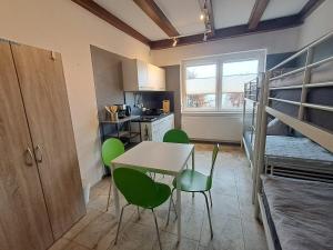 a room with a table and chairs and a bunk bed at Boardinghouse Wildbachtal in Boxtal