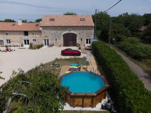 an aerial view of a house with a swimming pool at Esprit Charentais - The Byre in Londigny +8 photos