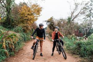 two people riding bikes on a dirt road at AfriCamps Magoebaskloof in Magoebaskloof