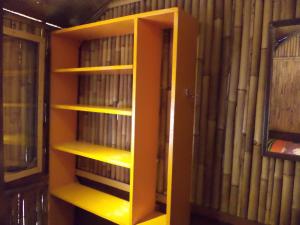 a book shelf filled with books in a room at Topi inn in Padangbai