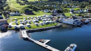 an aerial view of a marina with a boat in the water at Davik Fjordparadis in Bakken