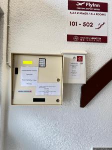 an elevator with a sign on the wall at FlyInn-Pension Airport-Messe in Leinfelden-Echterdingen