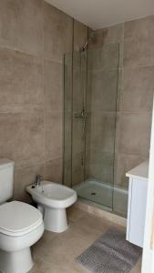 a bathroom with a toilet and a glass shower at Garden Inn II 5 in Santa Fe