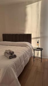 a bedroom with a white bed with towels on it at Garden Inn II 5 in Santa Fe