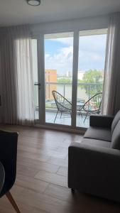 a living room with a couch and a balcony at Garden Inn II 5 in Santa Fe