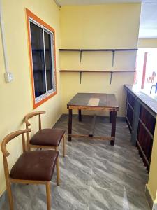 a room with a table and two chairs in it at Para Hostel Kohrong in Kaôh Rŭng (3) +33 photos