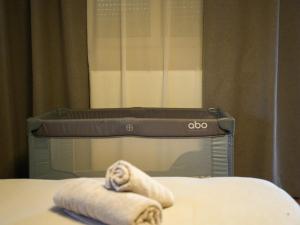 a close up of a bed with two towels at Villa Alaya in Kos