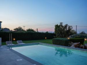 a swimming pool in a yard at dusk at Villa Alaya in Kos