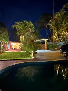 a car parked in front of a house with christmas lights at The Paradise Inn Kilimanjaro in Moshi