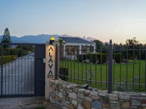 a gate with a sign in front of a fence at Villa Alaya in Kos