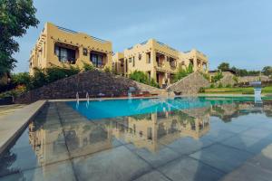 a house with a swimming pool in front of it at The Maridadi Hotel in Moshi