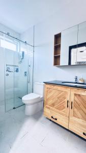 a bathroom with a toilet and a shower and a sink at Spacious Siem Reap Sanctuary in Phumi Ta Phul