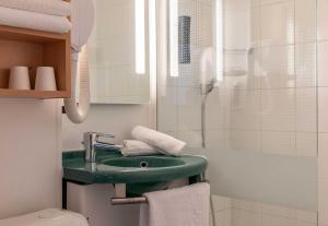 a bathroom with a green sink and a shower at B&B HOTEL Lourdes Centre Gare 3 étoiles in Lourdes +22 photos