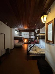 a room with two bunk beds and a fireplace at Casa Quixote in Braga