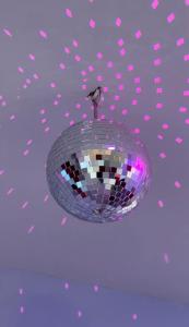 a disco ball hanging from a ceiling with pink hearts at Teddy in Malpe