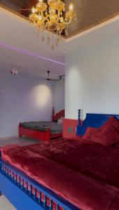 a bedroom with two beds and a chandelier at Teddy in Malpe