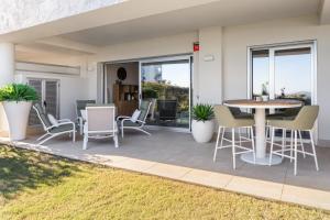 a patio with chairs and a table and a table at Solana Village in Málaga