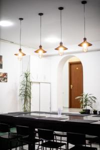 a large table in a room with chairs and lights at kutaisi hostel hub in Kutaisi