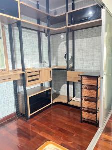 a room with a room with wooden shelves at Supalai Park Srinakarin Penthouse in Ban Nong Chaeng