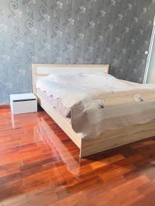a bedroom with a bed and a wooden floor at Supalai Park Srinakarin Penthouse in Ban Nong Chaeng +19 photos