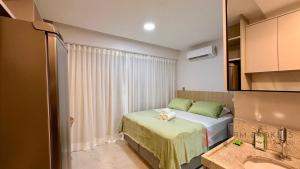 a small room with a bed and a sink at Flat Beira Mar 331 - 424 - 426 in João Pessoa