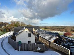 a building with snow on the ground next to a road at Apartment 14 in Aberystwyth