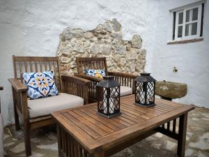 a room with two chairs and a wooden table at La Casa del Pastor 1890 in Benaocaz