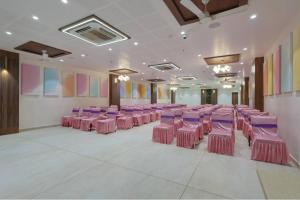 a room with pink and purple chairs in a room at Hotel Vivanta Inn Somnath in Somnath
