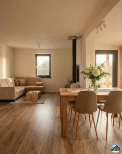 a living room with a table and chairs and a couch at Chata Hrbánik Tále in Bystrá