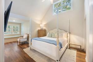 a bedroom with a white bed and a window at SM05: 5 Silver Moss in Kiawah Island +42 photos